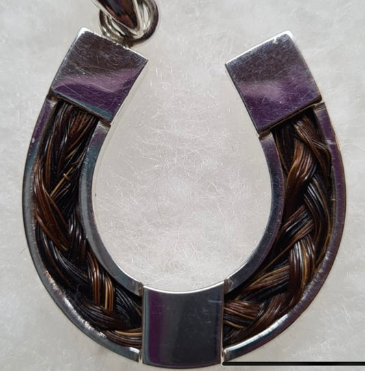 Horse shoe with hair pendant